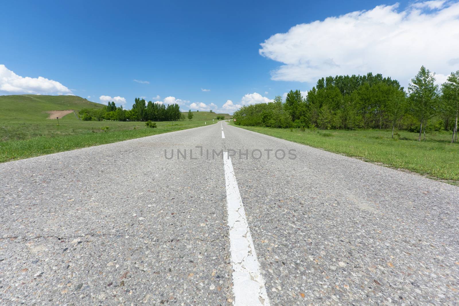 Road in farming fields in mountain with blue sky in spring day