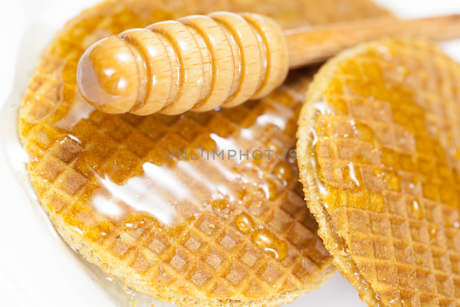 A hearty breakfast of golden brown waffles covered in honey