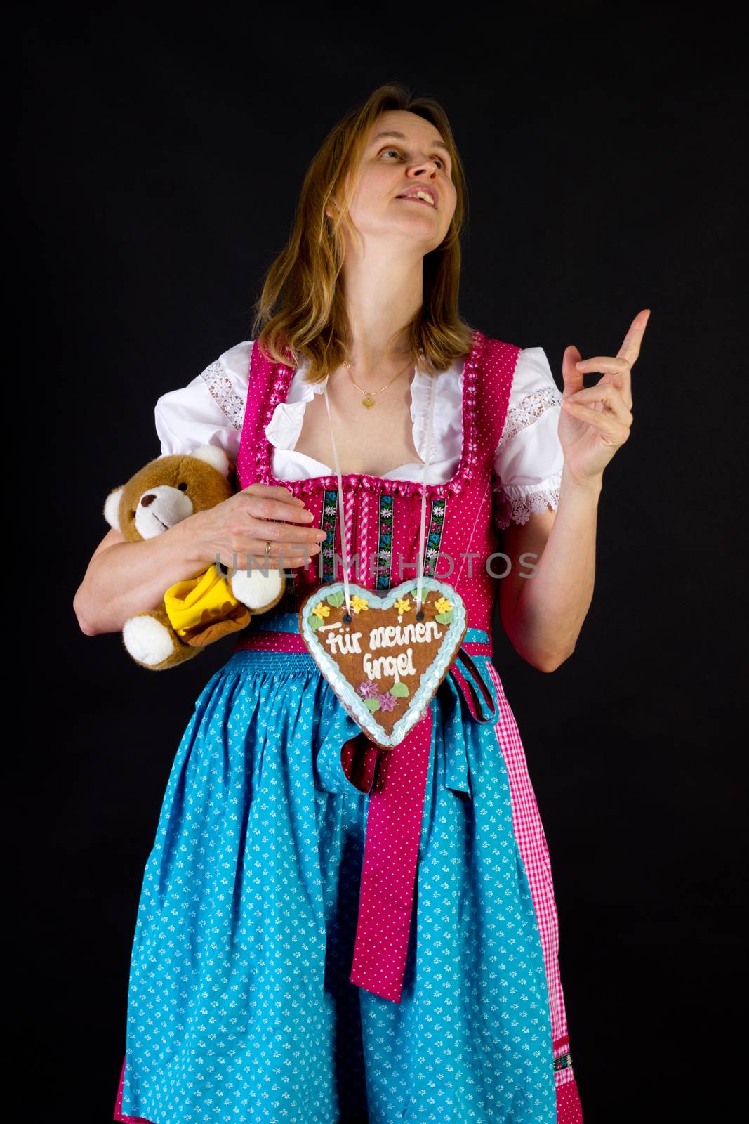 Woman in dirndl pointing at something