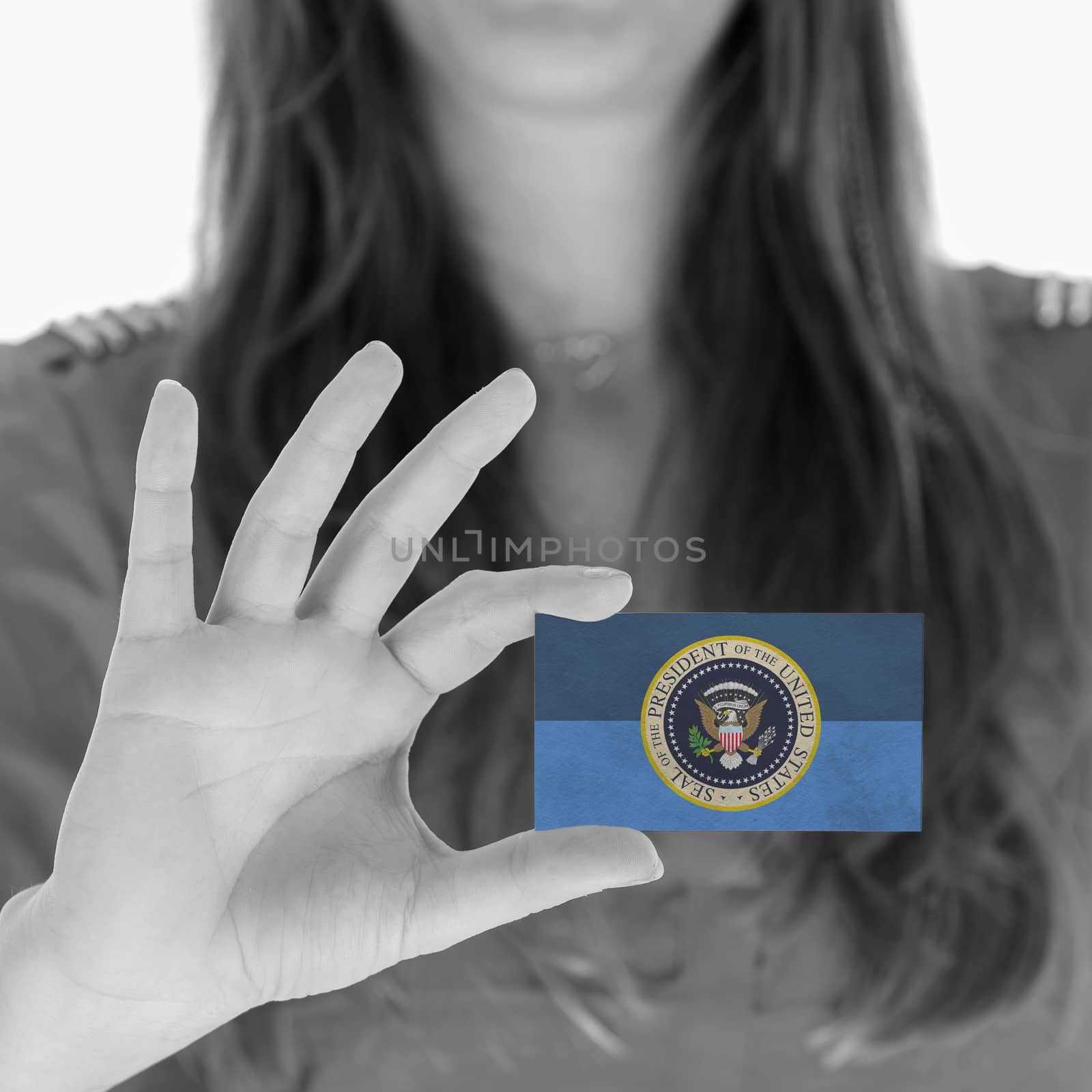 Woman showing a business card, Presidential Seal