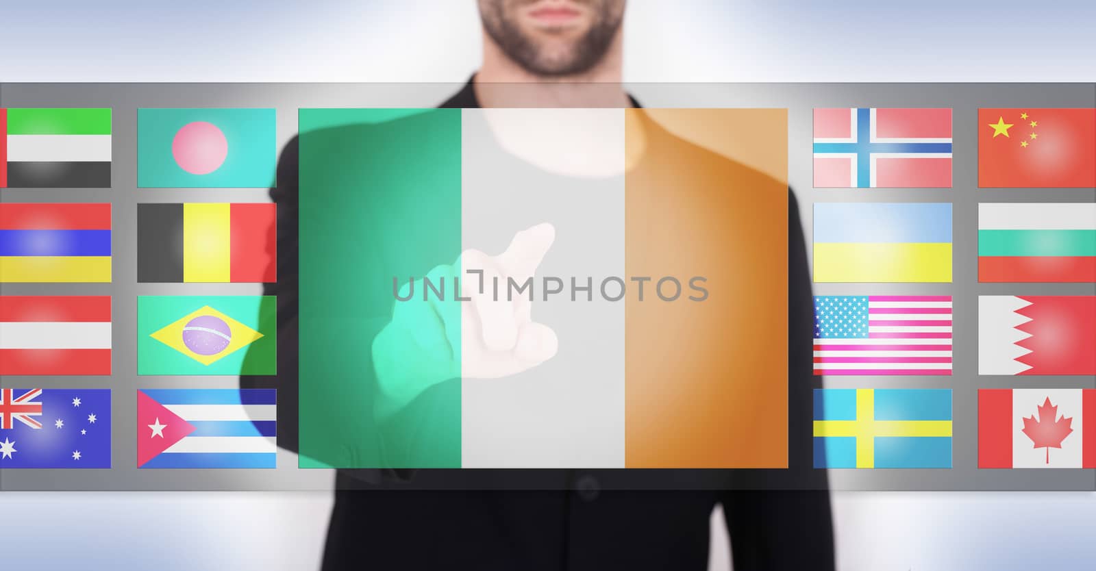 Hand pushing on a touch screen interface, choosing language or country, Ireland