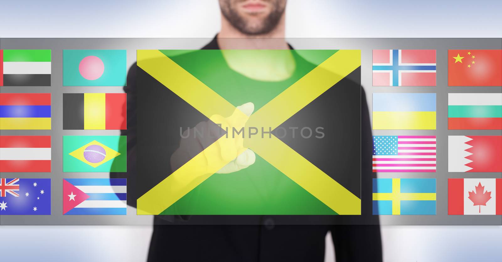 Hand pushing on a touch screen interface, choosing language or country, Jamaica