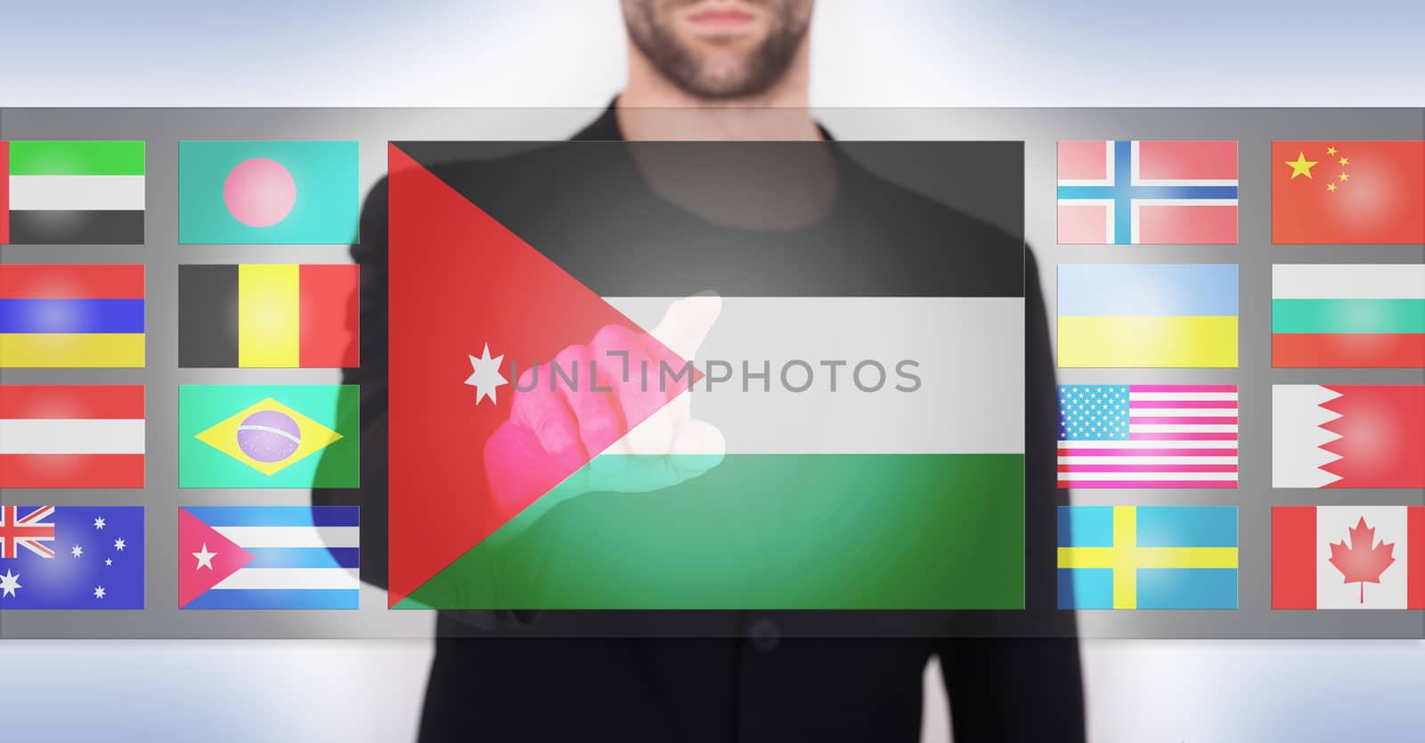 Hand pushing on a touch screen interface, choosing language or country, Jordan