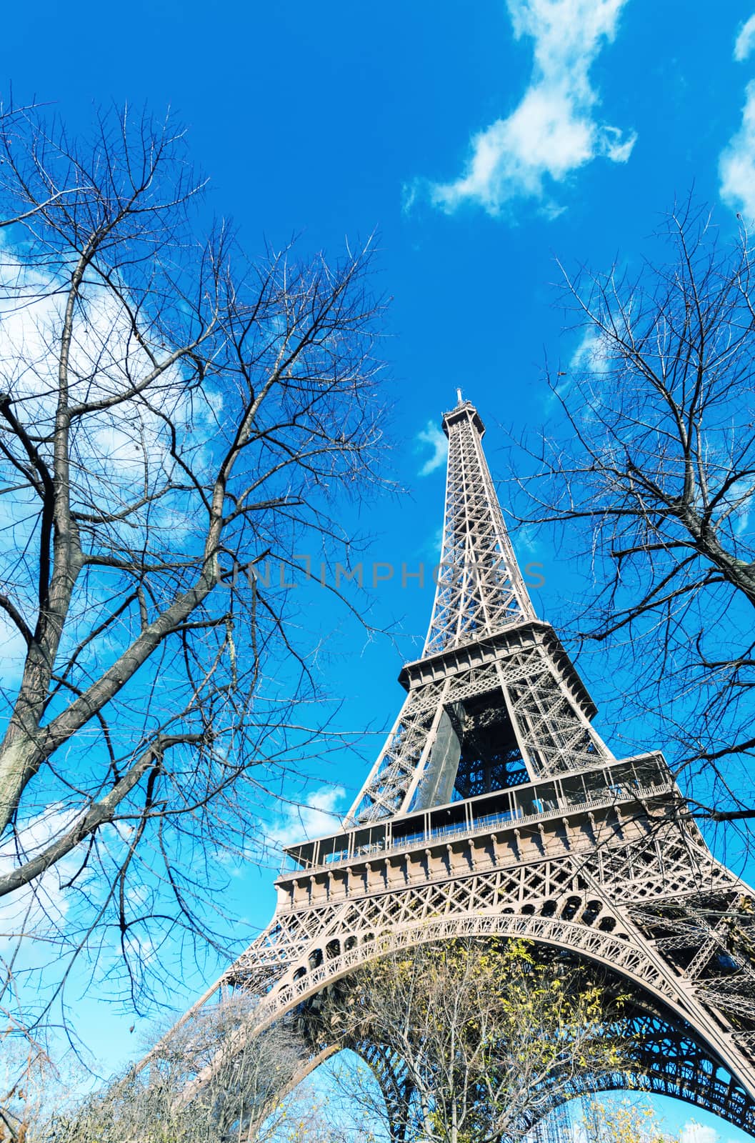 Spectacular view of Tour Eiffel structure on a beautiful sunny day. Eiffel Tower under blue sky, Paris.