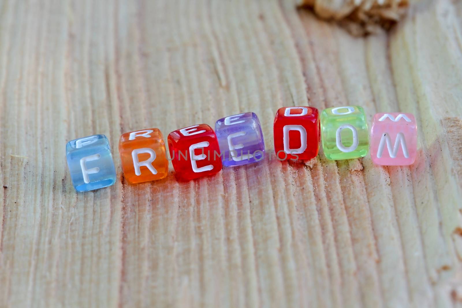 Photo shows details of freedom sign on the wooden background.