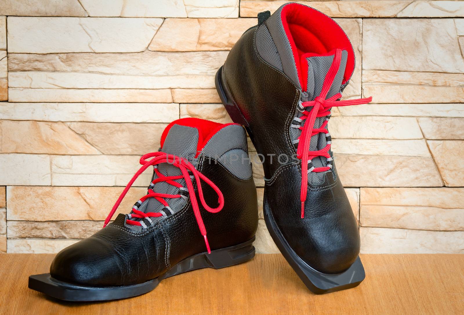 Black boots with red finishing for skiing.