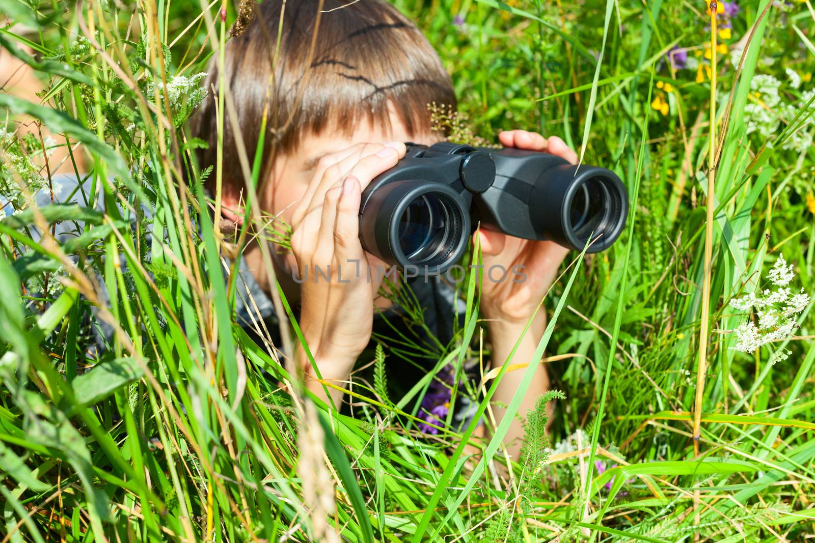 Child looking through binoculars by naumoid