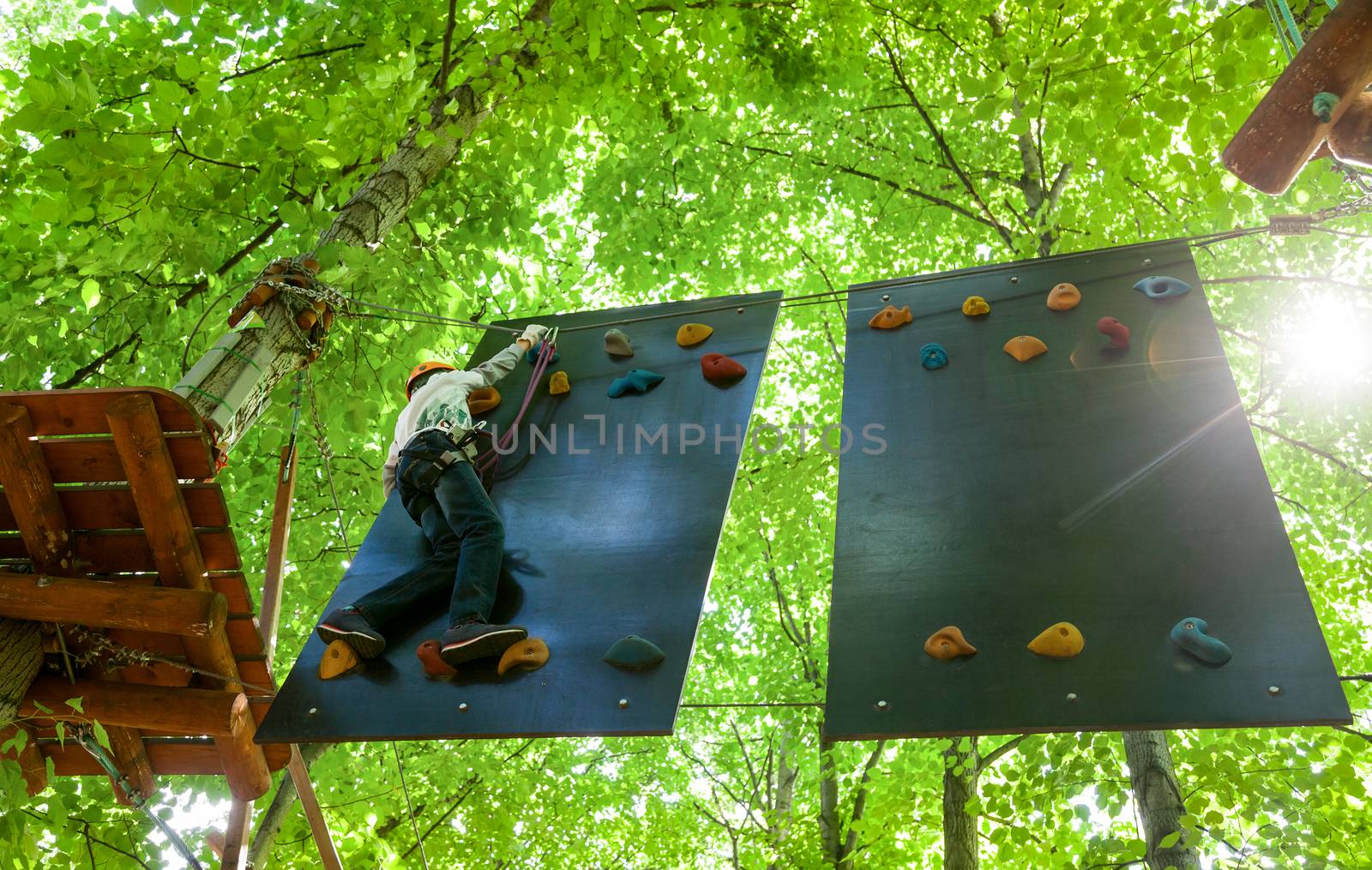 Kid in a treetop adventure park by naumoid