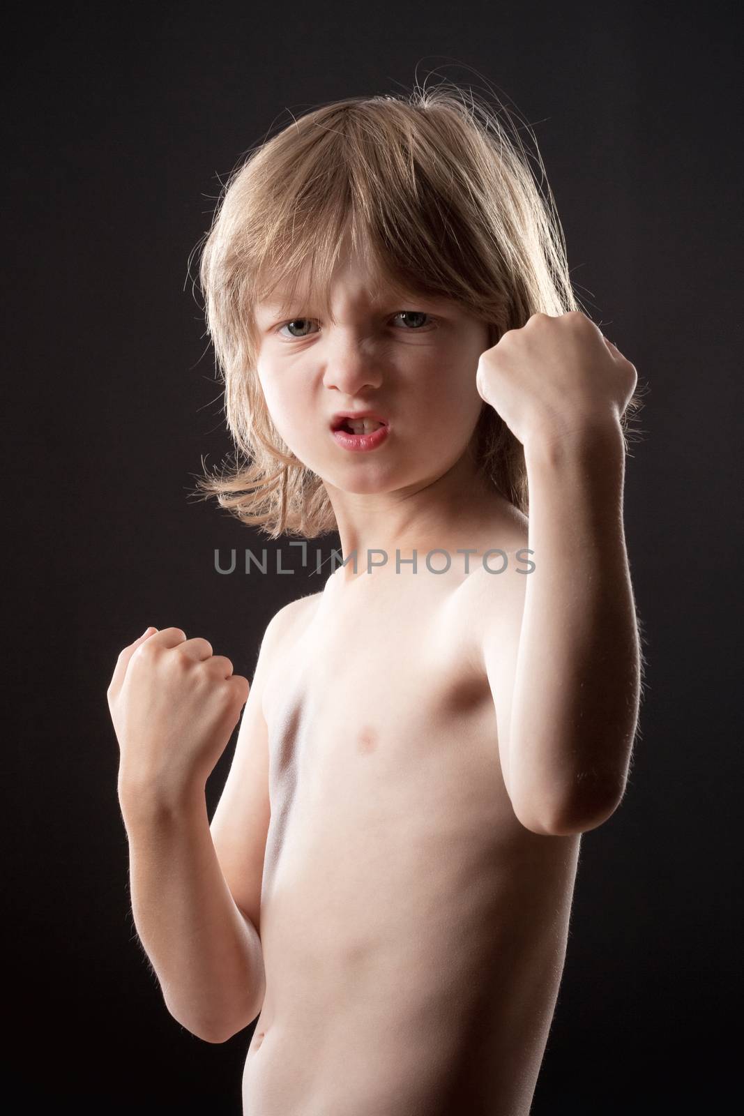 Boy with Blond Hair Striking a Fighting Pose