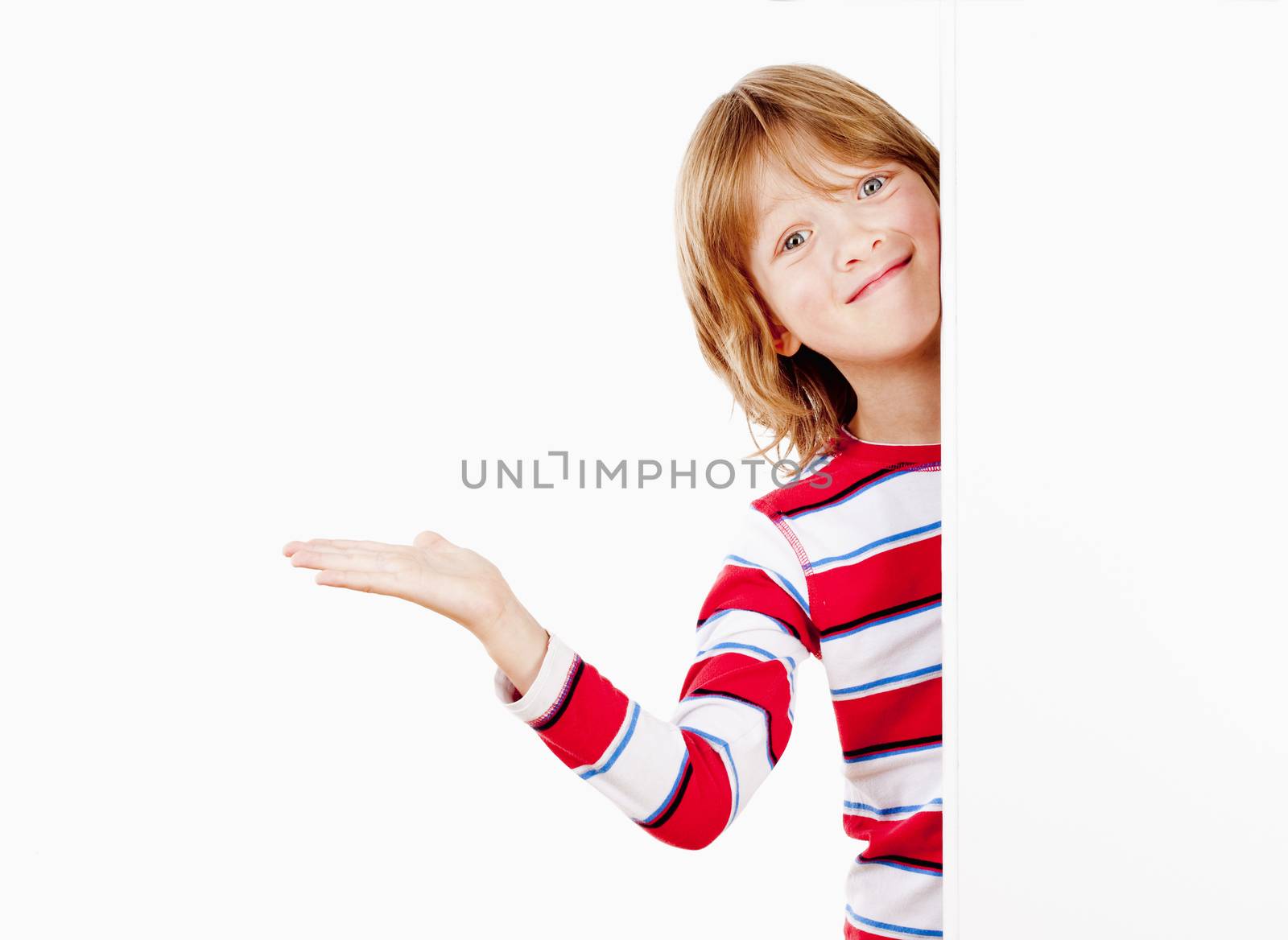 Boy Peeking Out From Behind A White Board With His Arm Outstretched