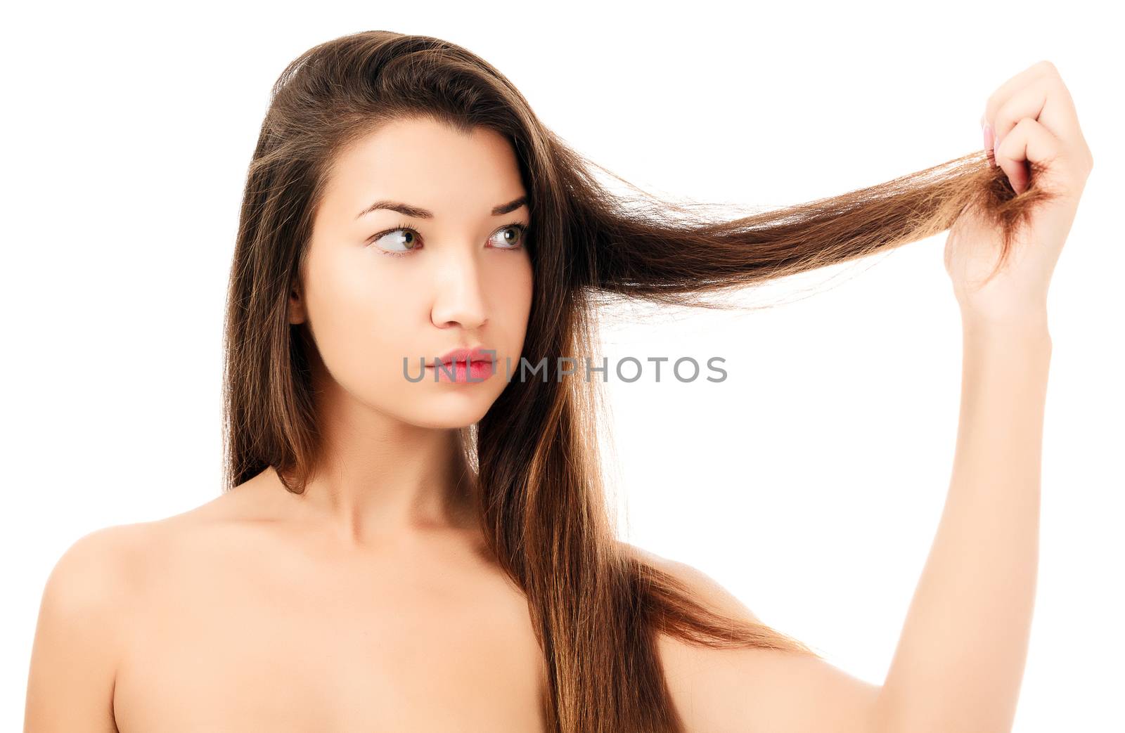 woman looking on her fragile hair, white background, copyspace by Nobilior