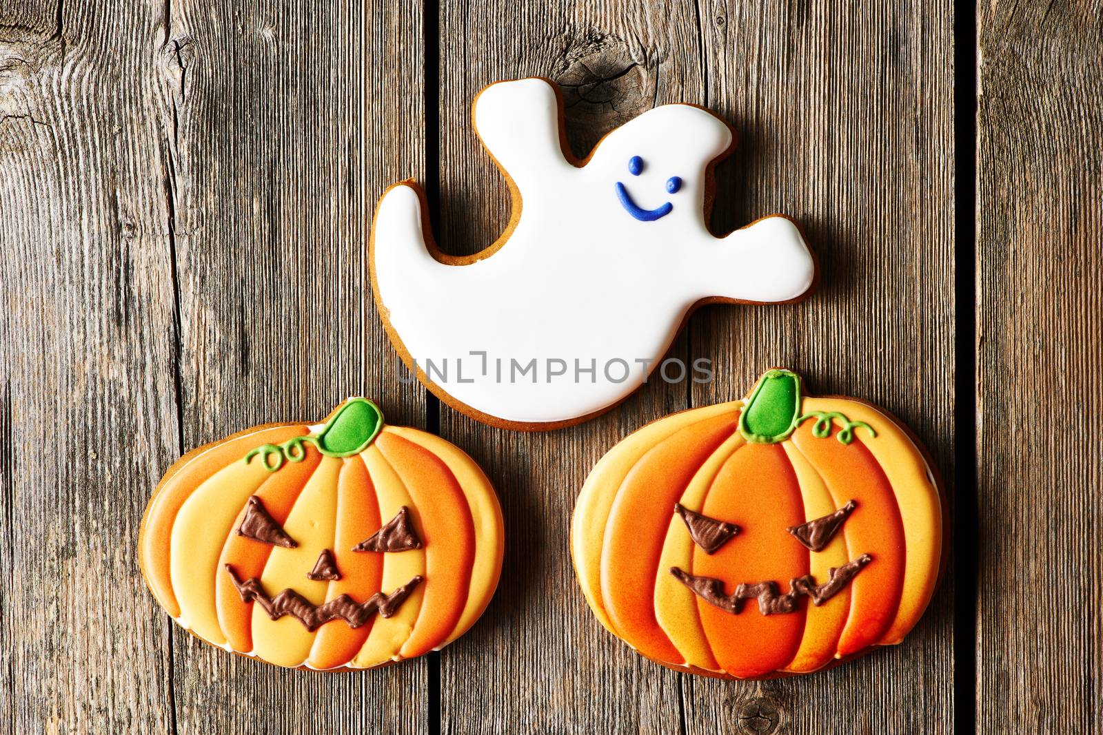 Halloween homemade gingerbread cookies over wooden table