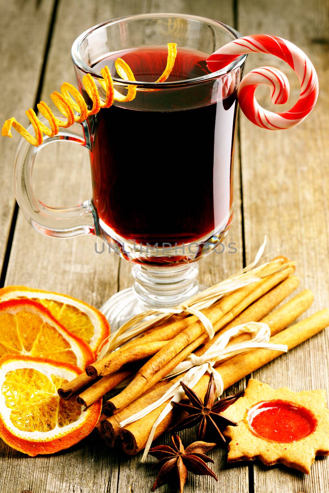 Glass of red mulled wine on wooden table