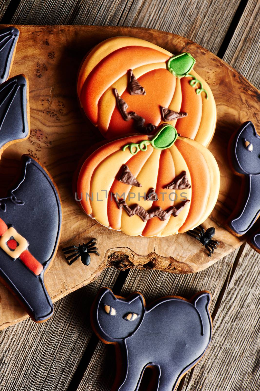 Halloween homemade gingerbread cookies over wooden table