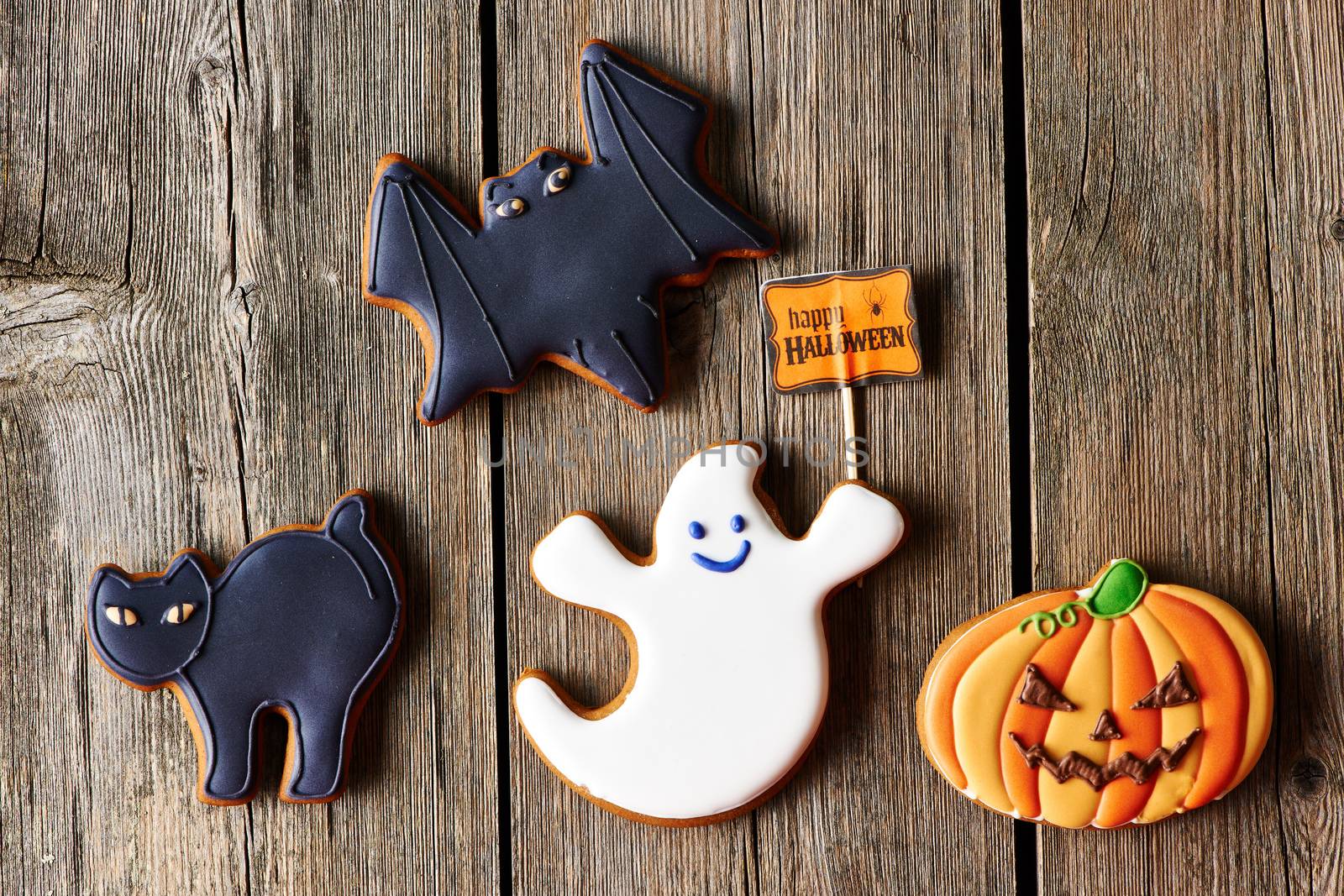 Halloween homemade gingerbread cookies over wooden table