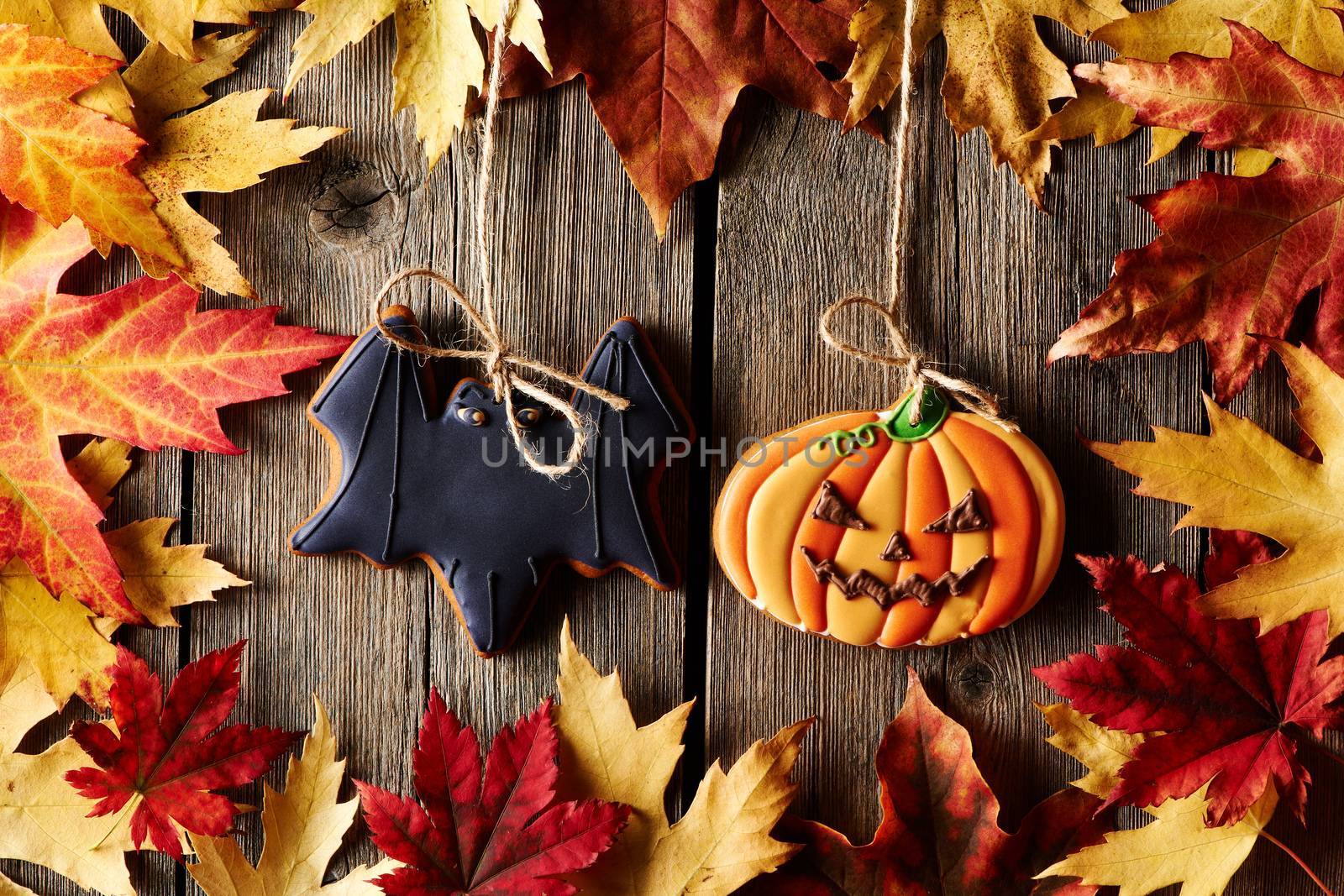 Halloween homemade gingerbread cookies over wooden background