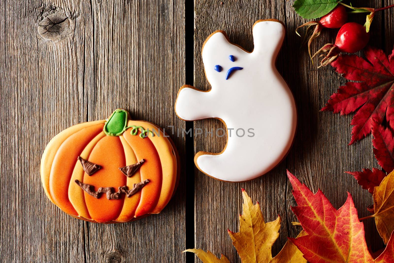 Halloween homemade gingerbread cookies over wooden background