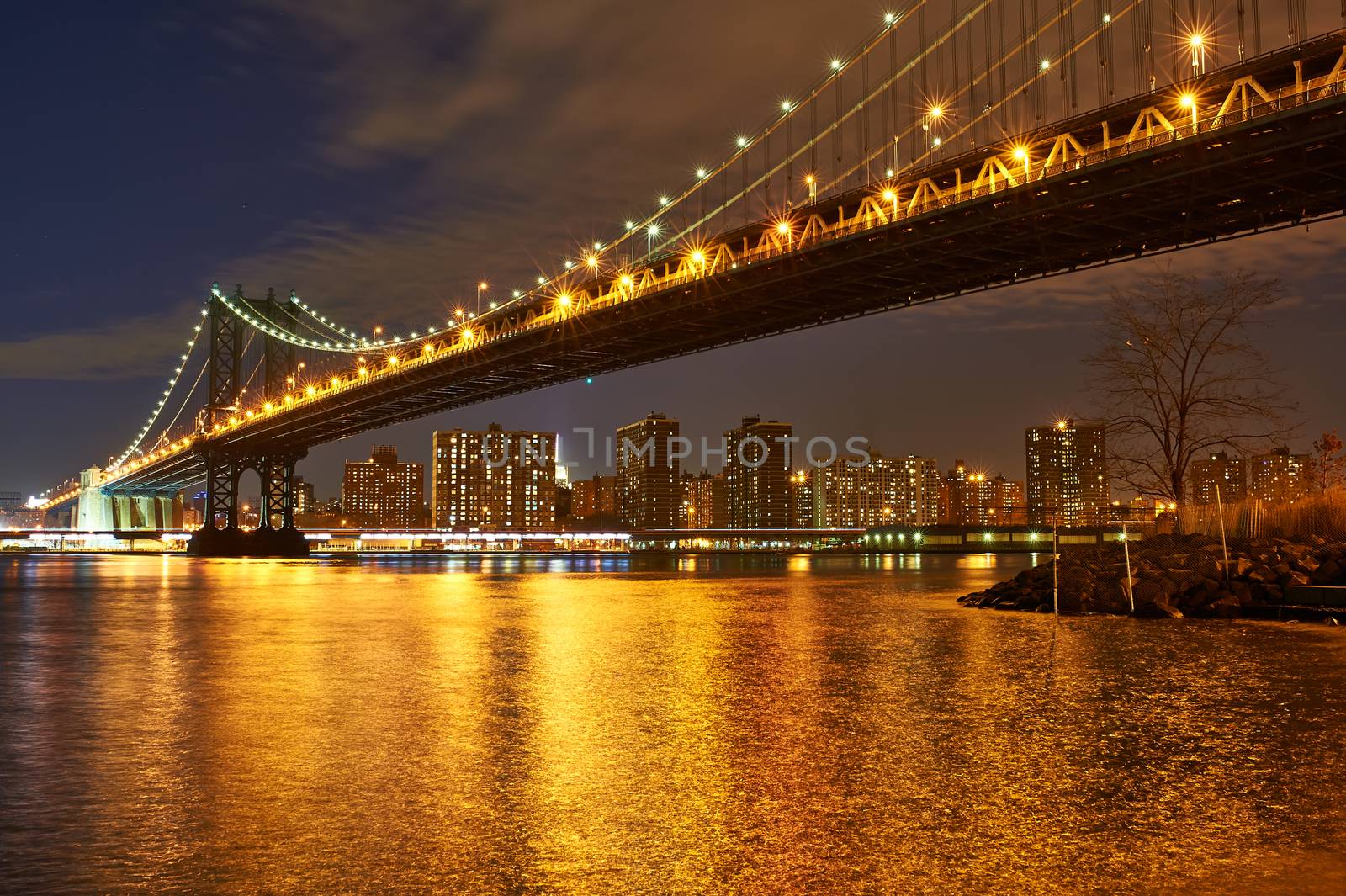 Manhattan Bridge and skyline view from Brooklyn in New York City at night