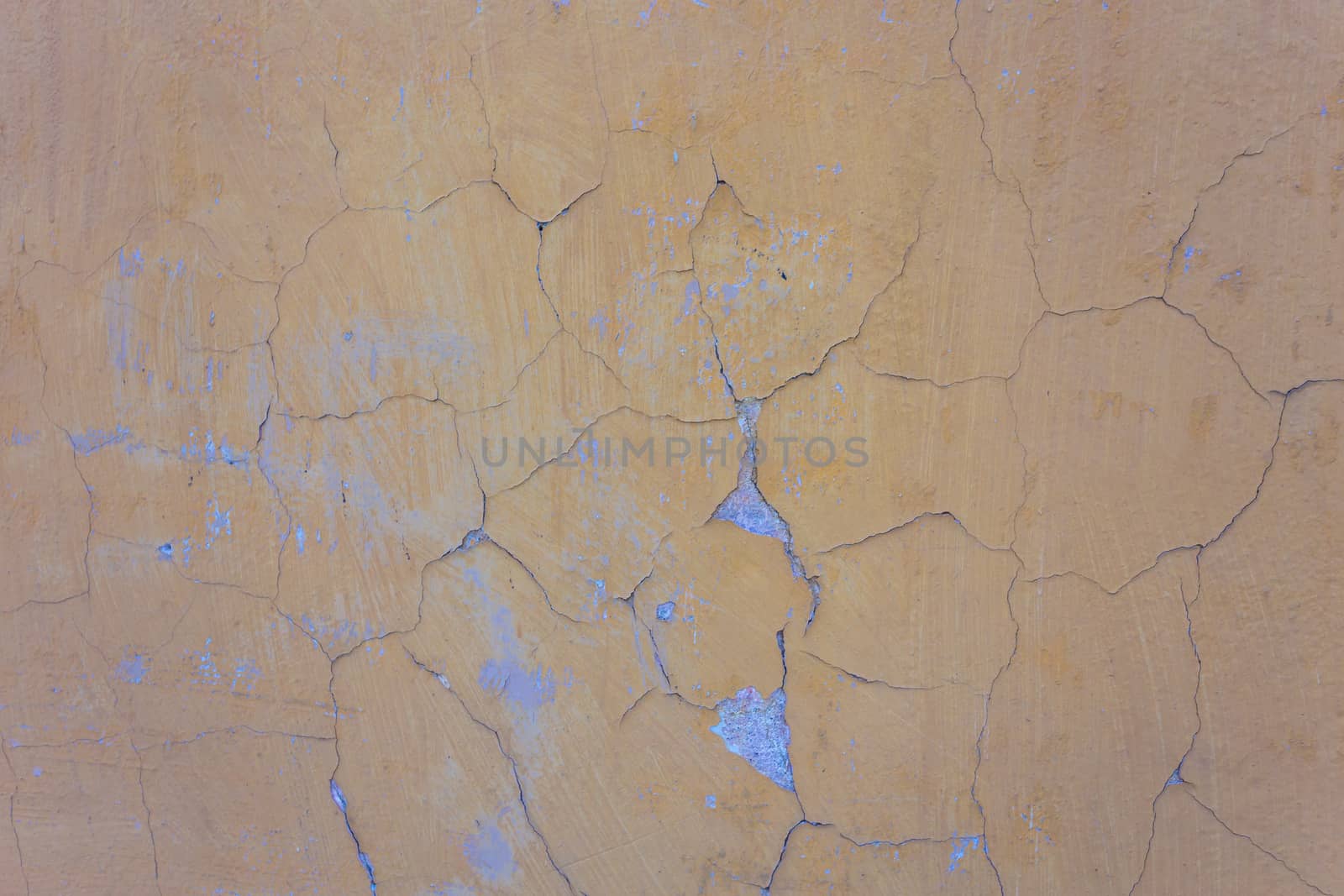 Yellow wall with cracks and peeling paint in grunge, seamless texture