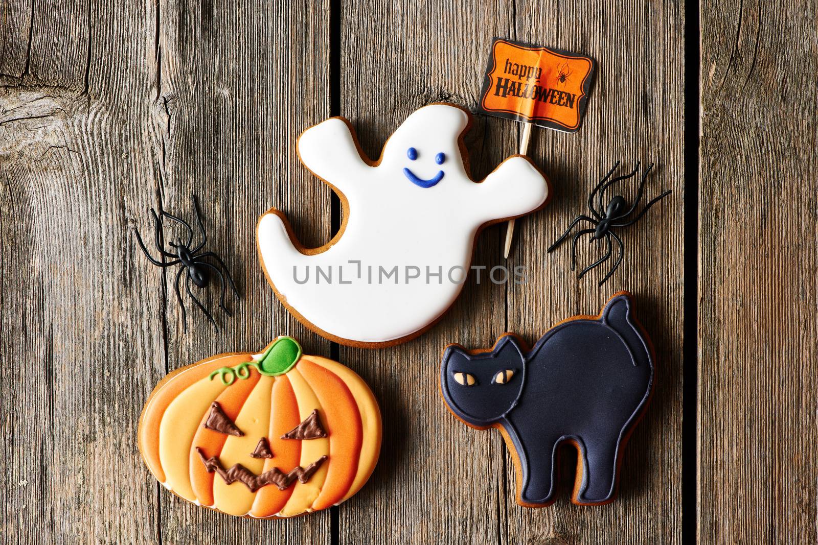 Halloween homemade gingerbread cookies over wooden table