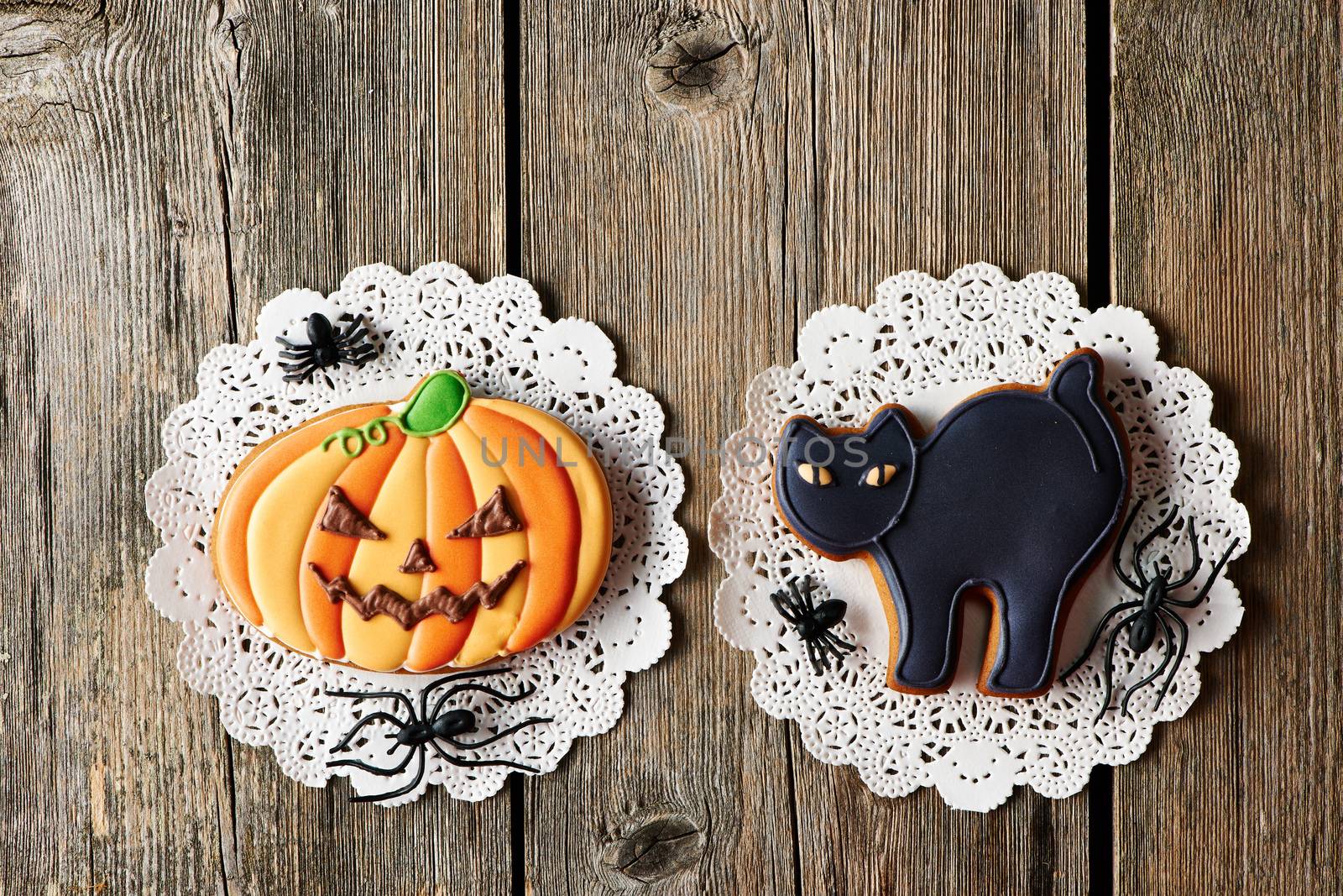 Halloween homemade gingerbread cookies over wooden table