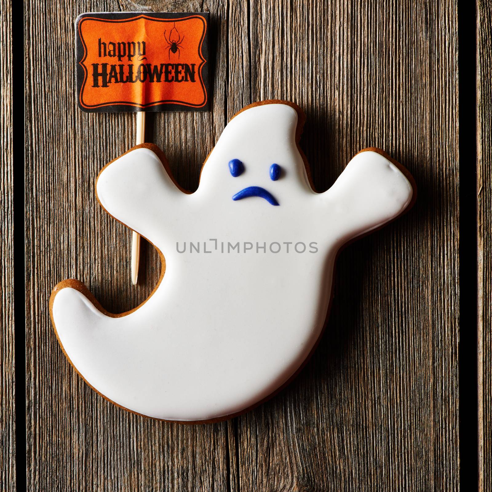 Halloween homemade gingerbread cookie over wooden table