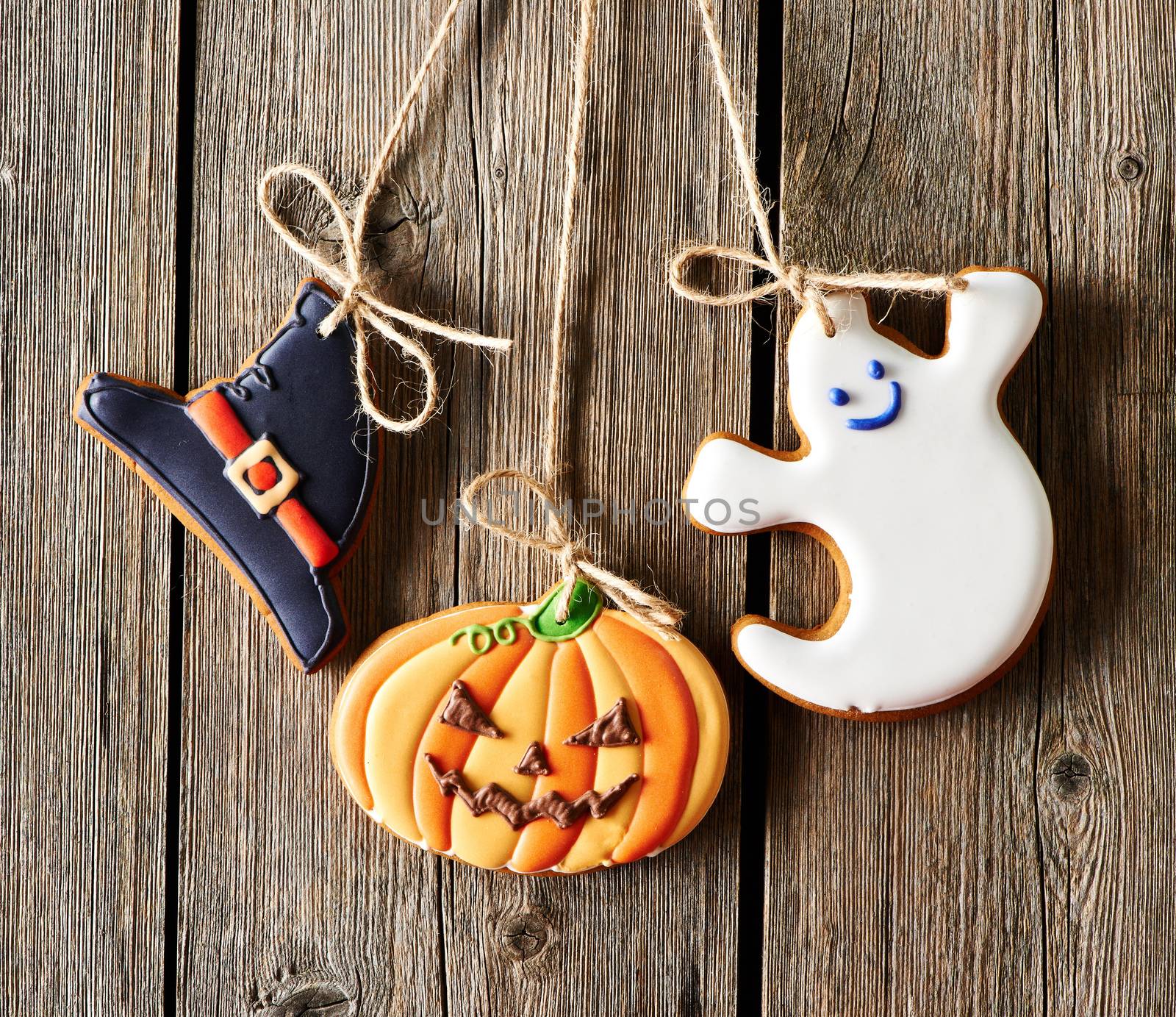 Halloween homemade gingerbread cookies over wooden background