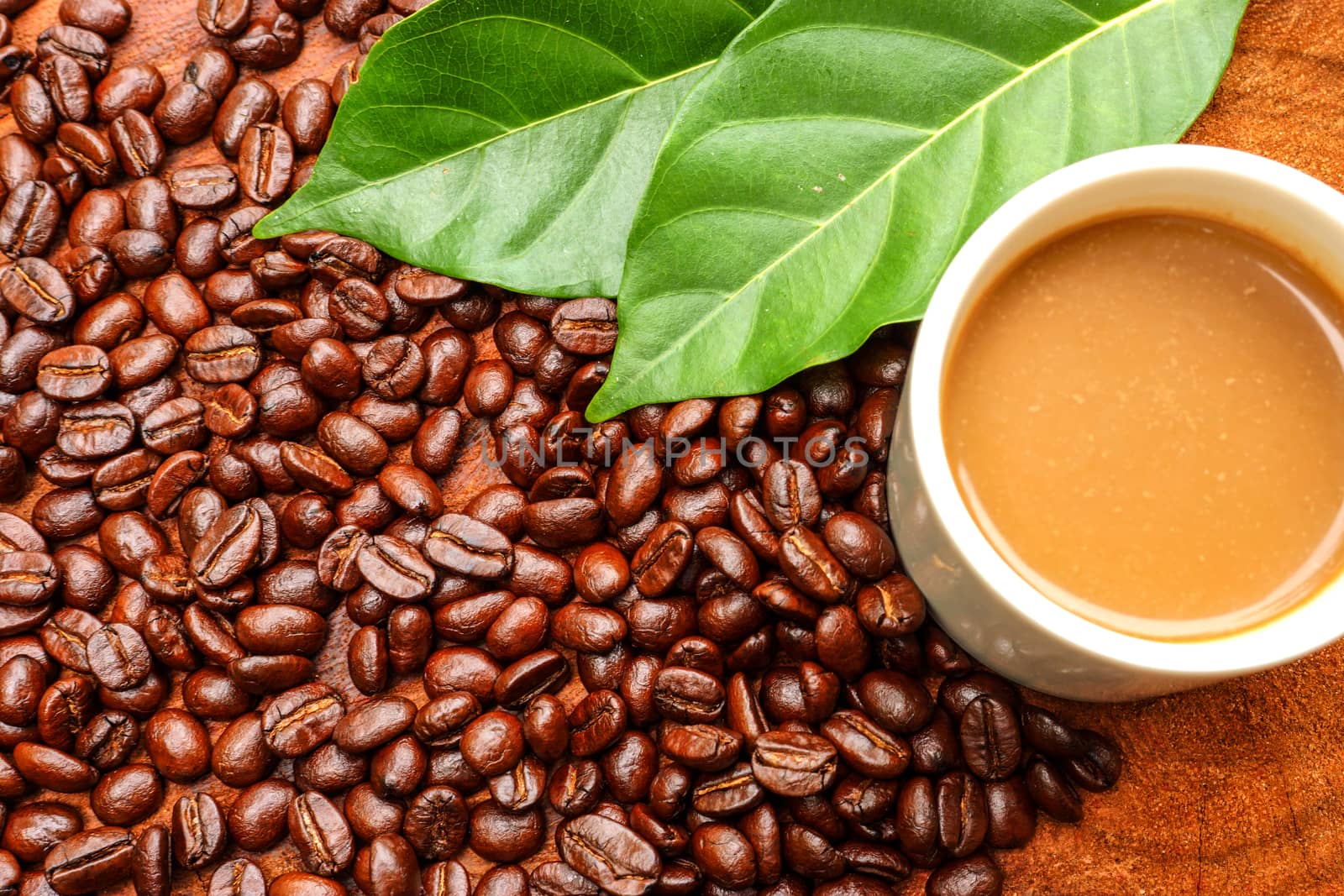 Coffee and beans on the wooden background.