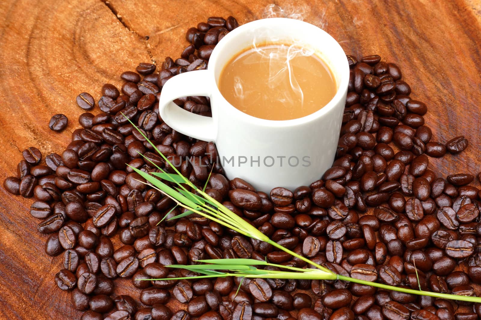 Coffee and beans on the wooden background.