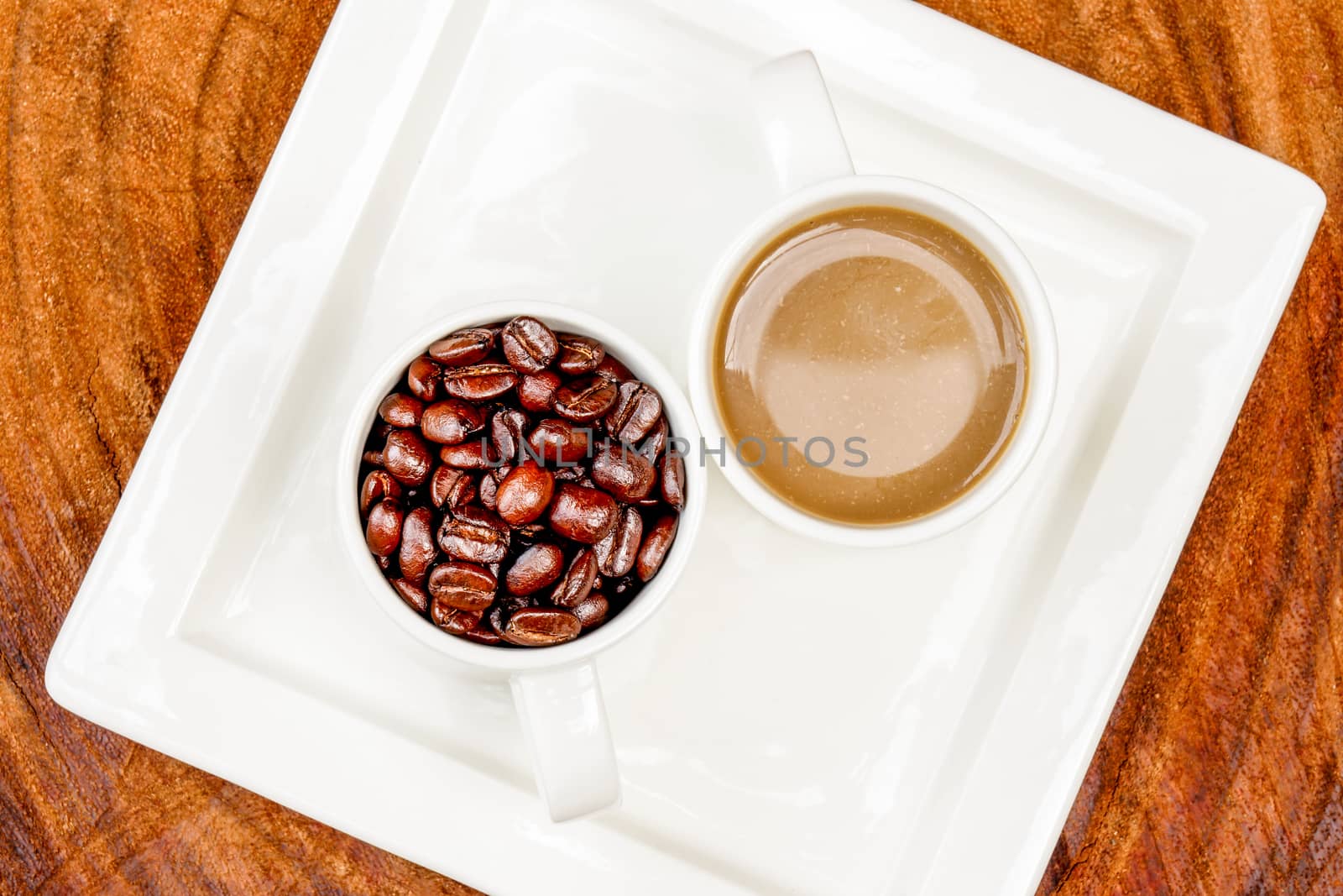 Coffee and beans on the wooden background.