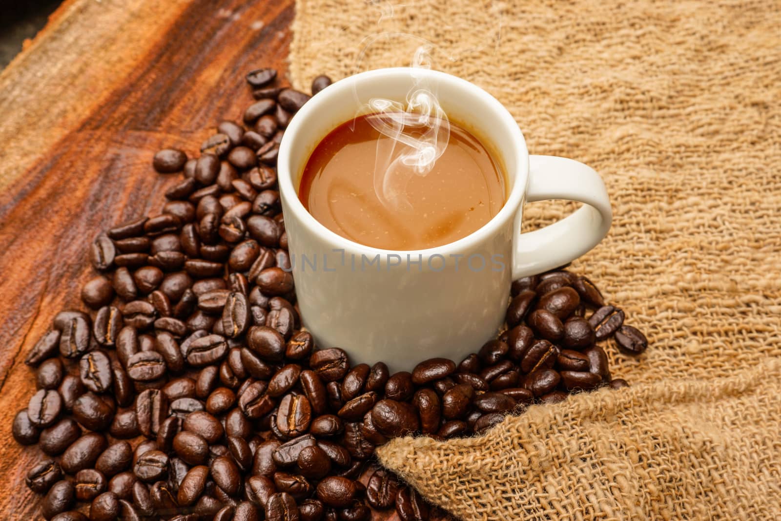 Coffee and beans on the wooden background.