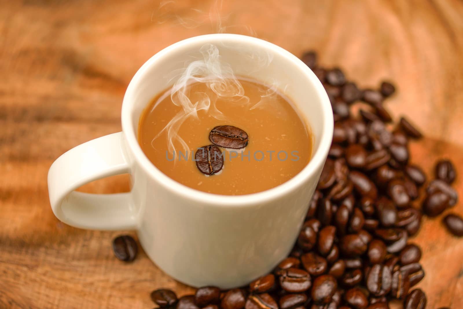 Coffee and beans on the wooden background.