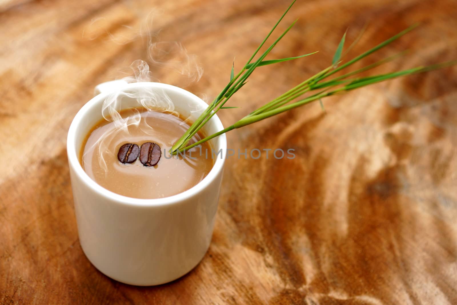 Coffee and beans on the wooden background.