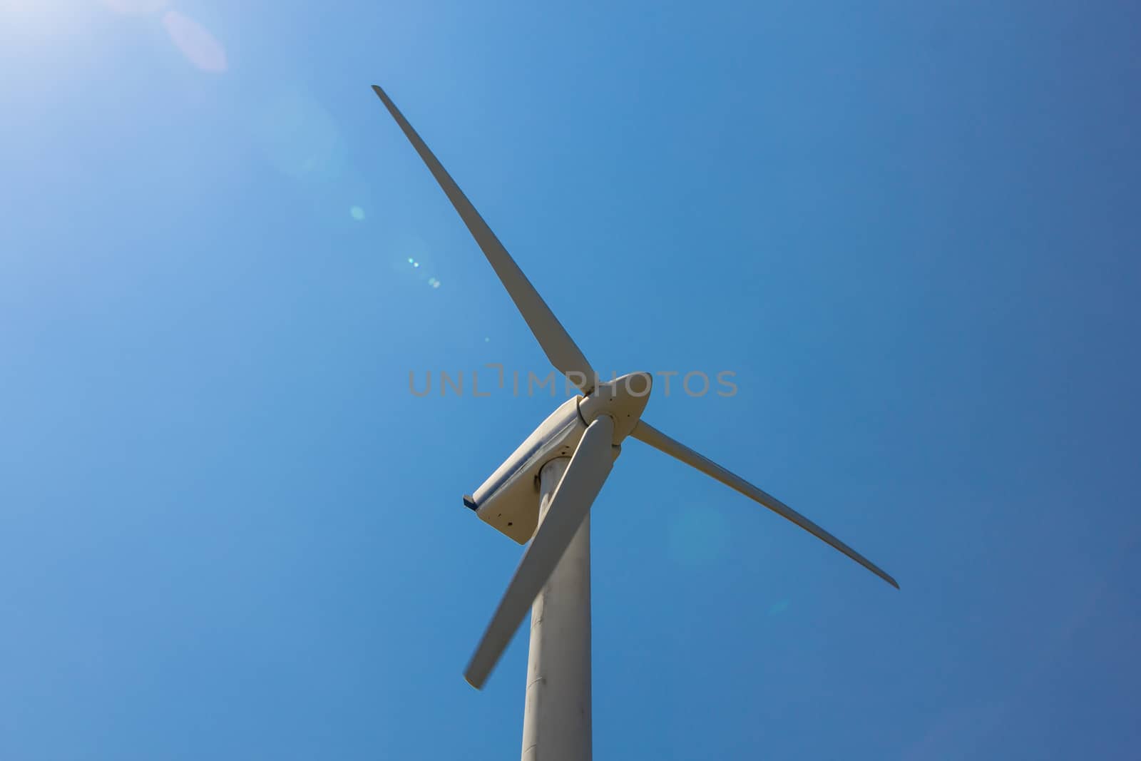 Wind turbine over the blue sky by huntz