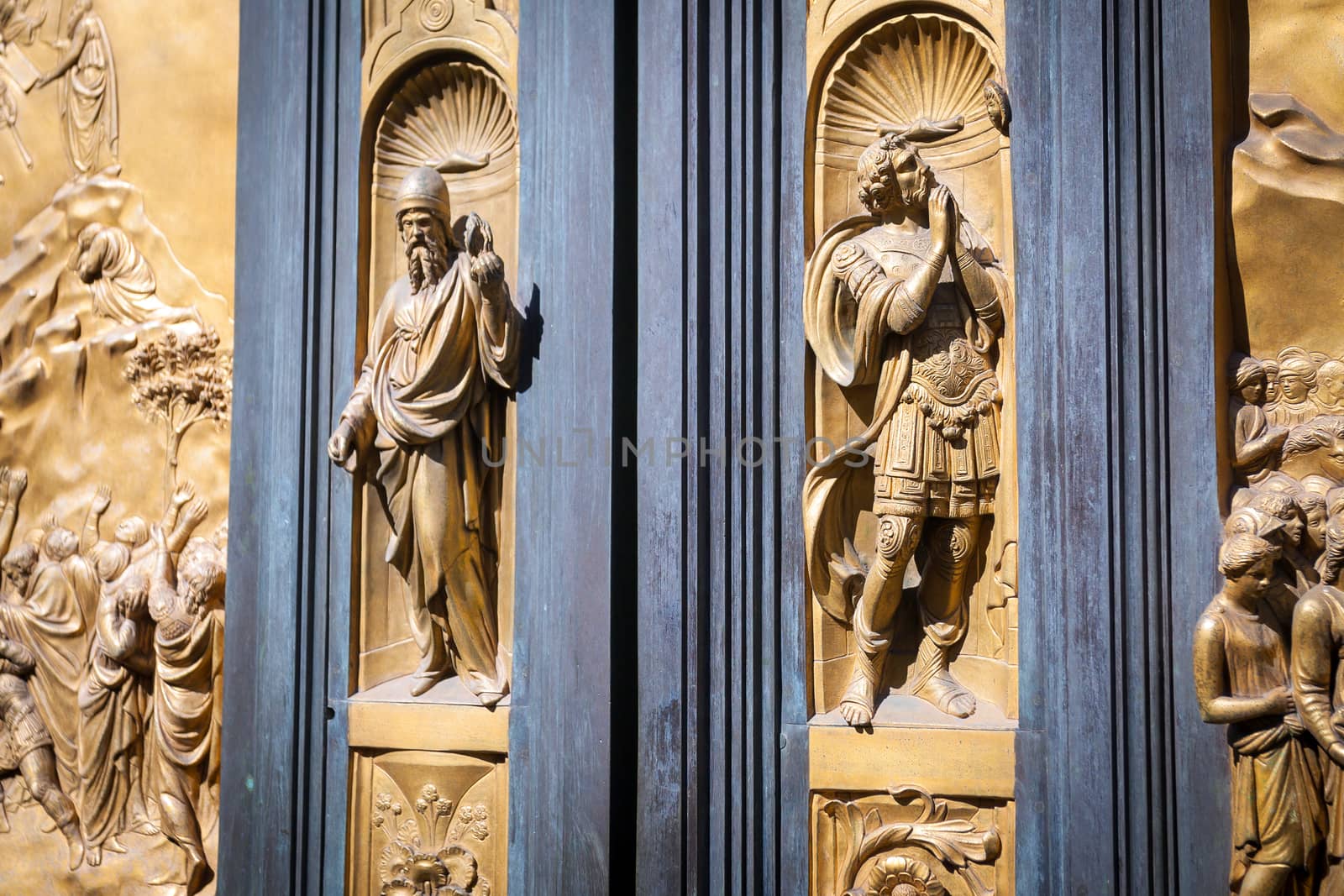 Pisa, Italy - August 11, 2013: Detail with soldier praying on the Gate of Paradise - Baptistery of San Giovanni, Florence Italy