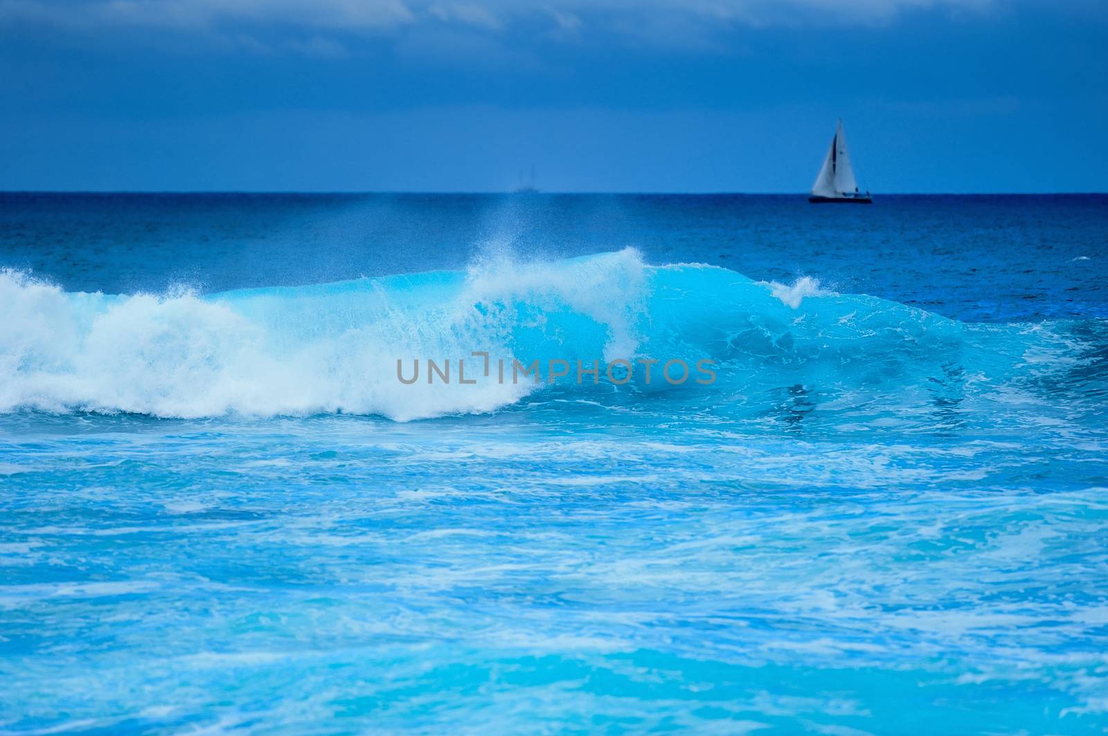 Yacht with white sails in the open sea