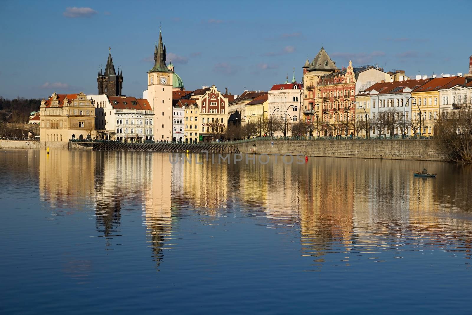 Photo shows various historical houses, Vltava river, bridges and other architectural details.