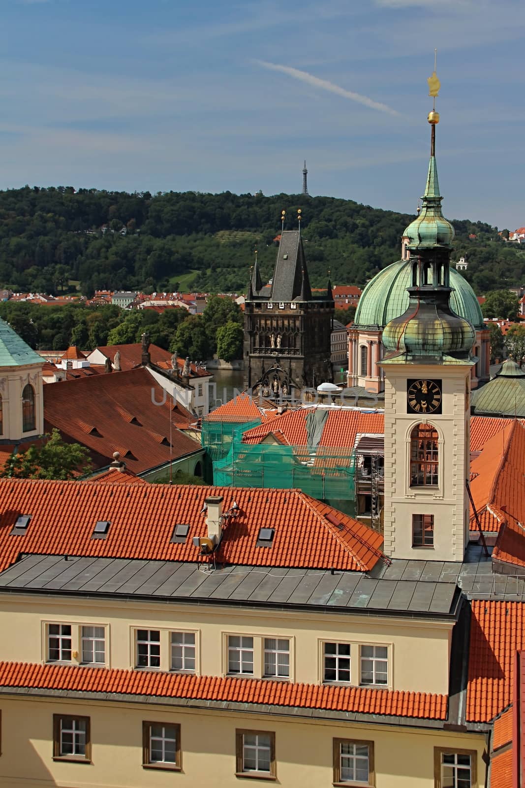 Photo shows details of Prague red roofs and old houses.