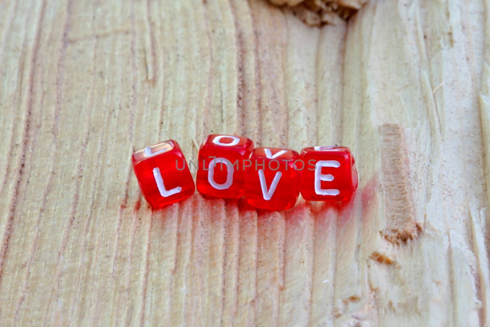 Photo shows details of love sign on the wooden background.