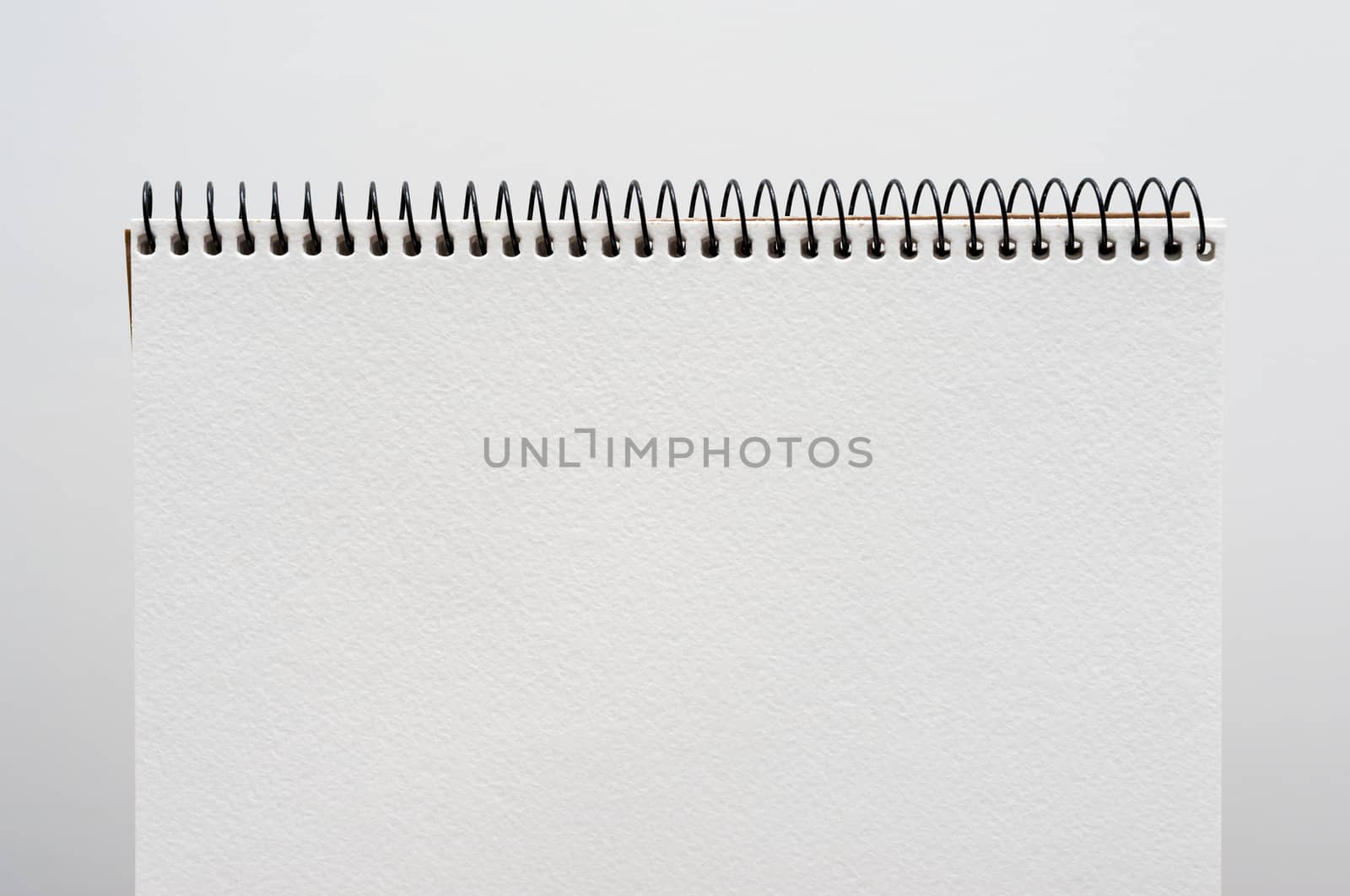 close up of a blank white notebook on white background