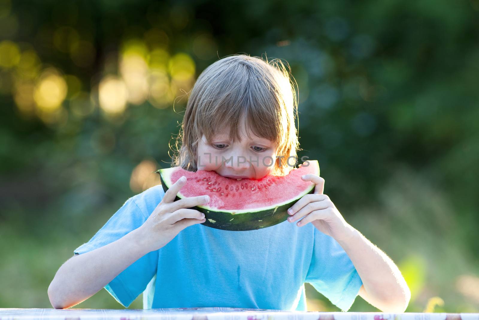 Boy Eating Watermelon Outdoors