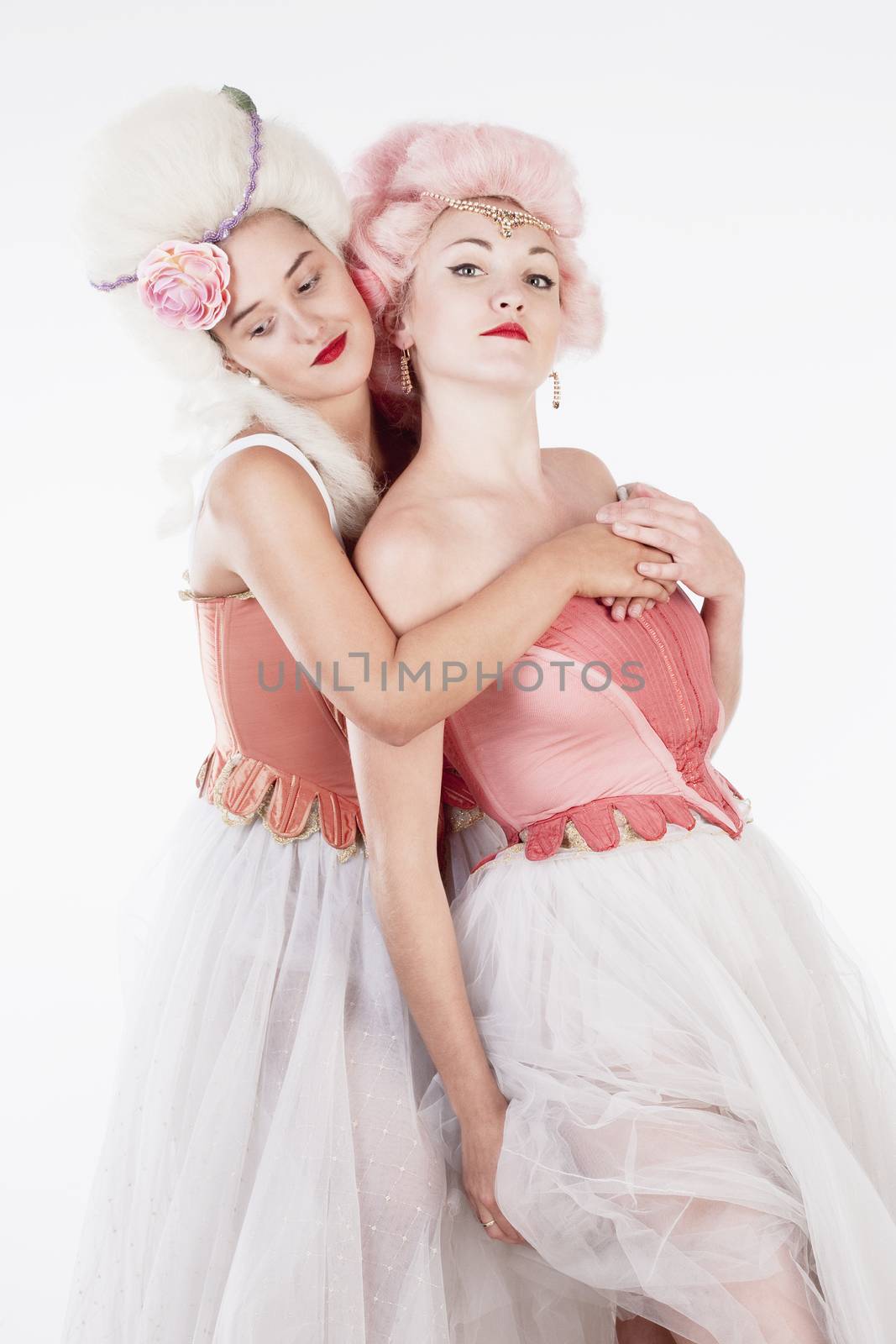 Two Young Female Friends in Historical Costumes Embracing