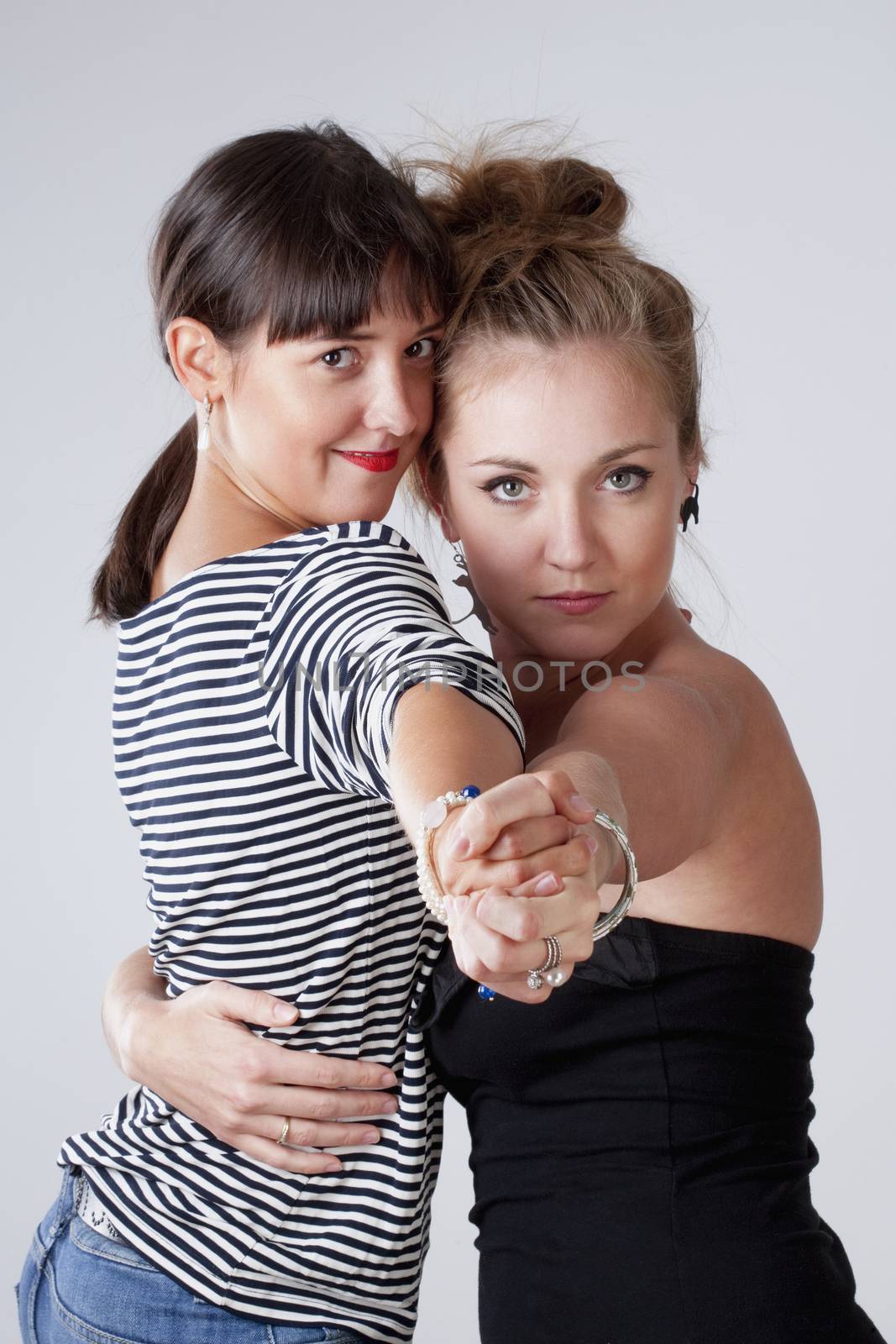 Two Young Female Friends Dancing Tango - Isolated on Gray