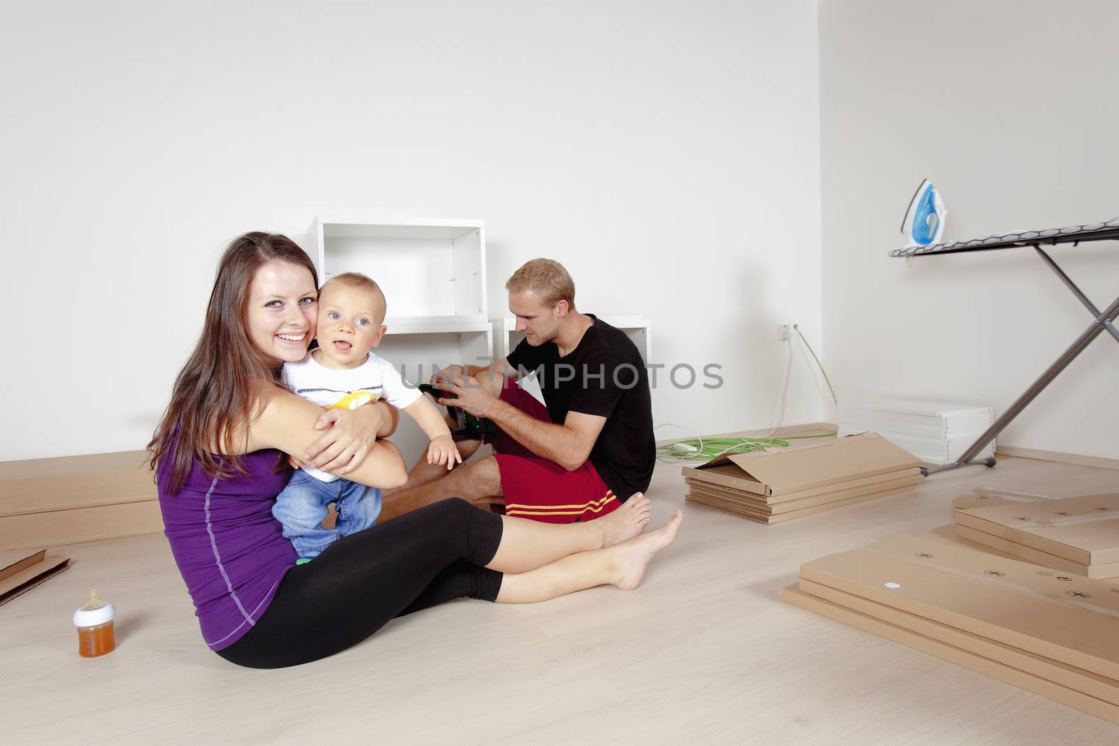 Young Family with a Baby Moving by courtyardpix
