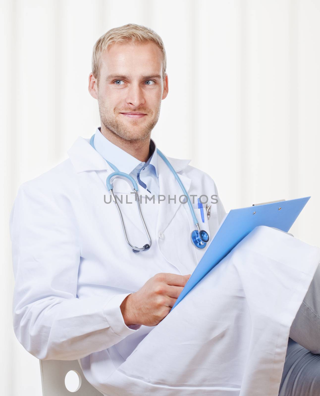 Portrait of a Young Doctor with Stethoscope and Files