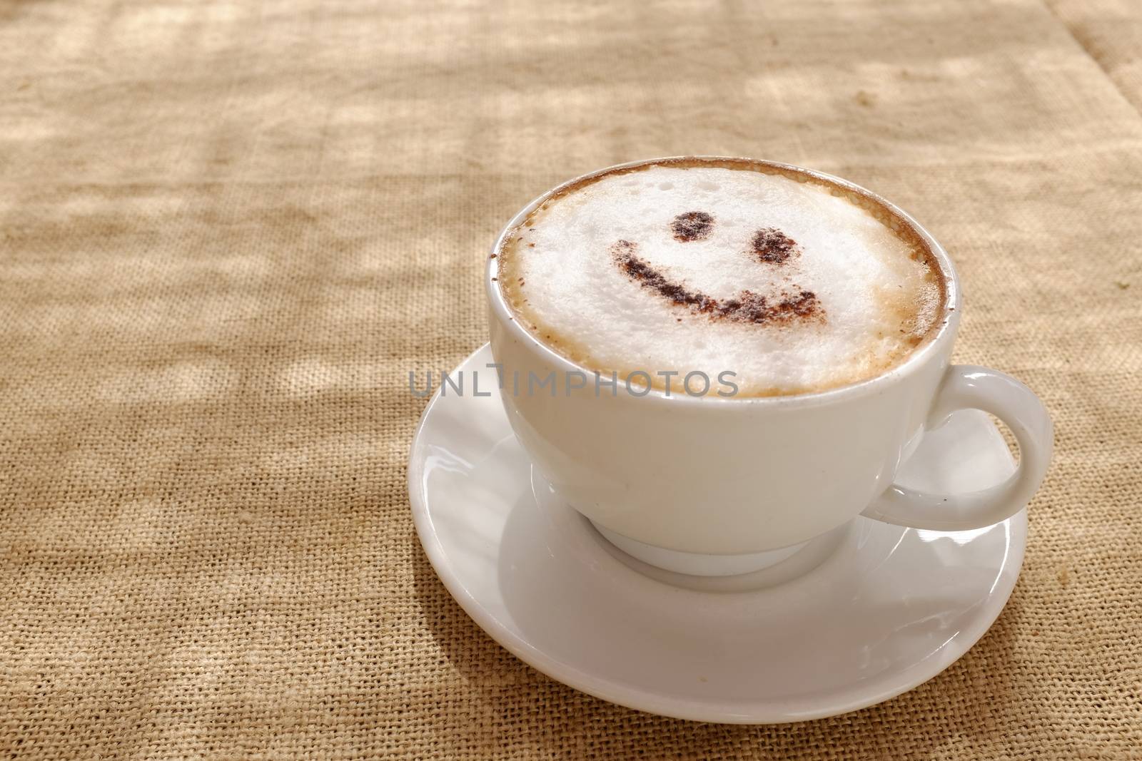 Coffee cappuccino with foam or chocolate smiling welcome happy face in restaurant or hotel