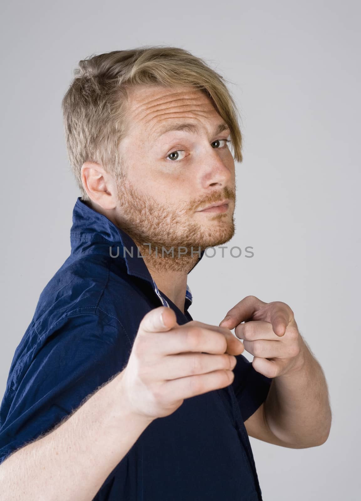 Young Man Making a Pointing Gesture with his Fingers