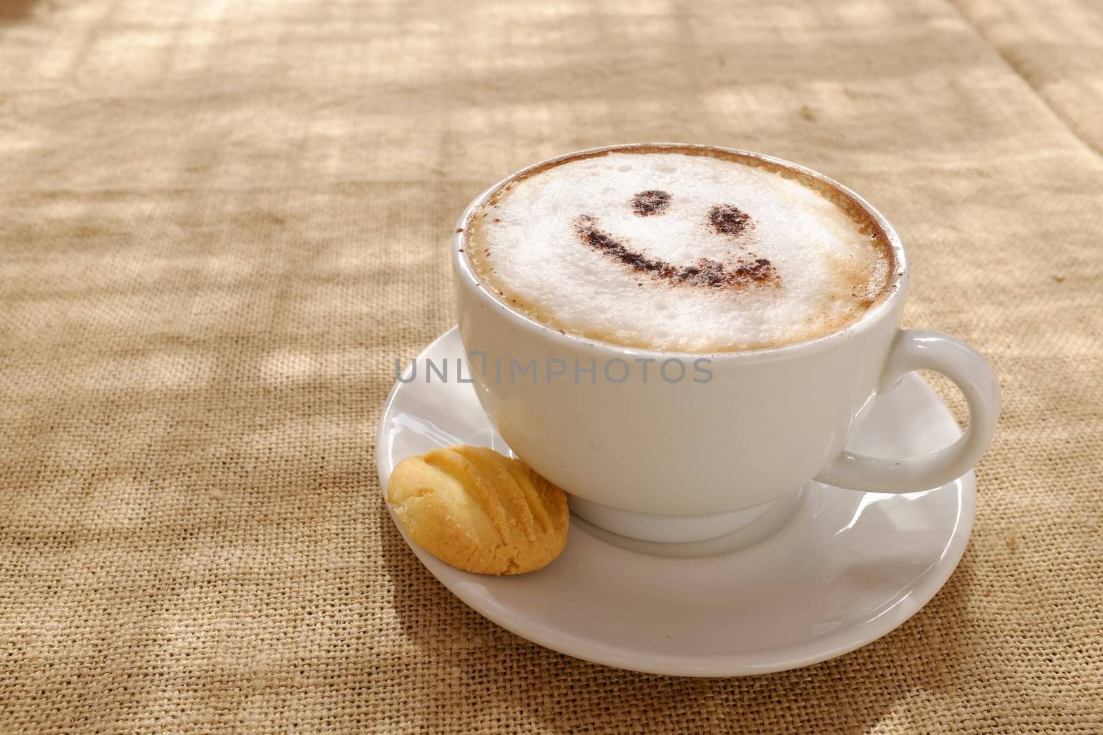 Coffee cappuccino with foam or chocolate smiling welcome happy face in restaurant or hotel