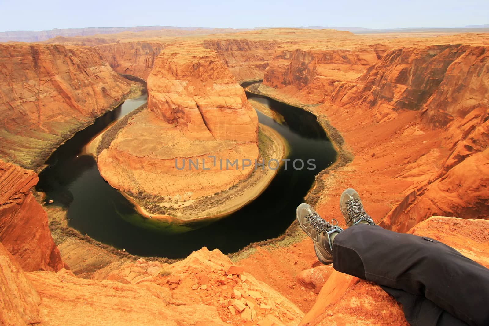 Pair of legs at Horseshoe bend overlook, adventure concept  by donya_nedomam