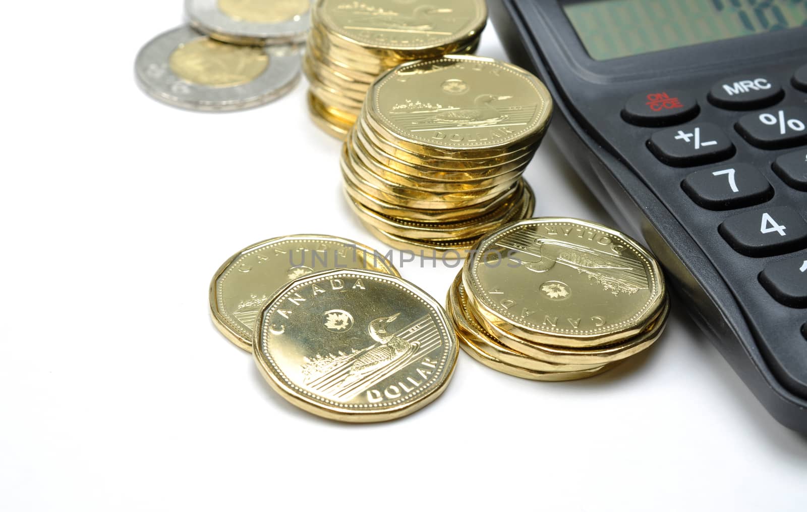 Calculator and coins on white background